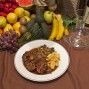 Plato de rabo de toro acompañado de patatas fritas y variedad de verduras